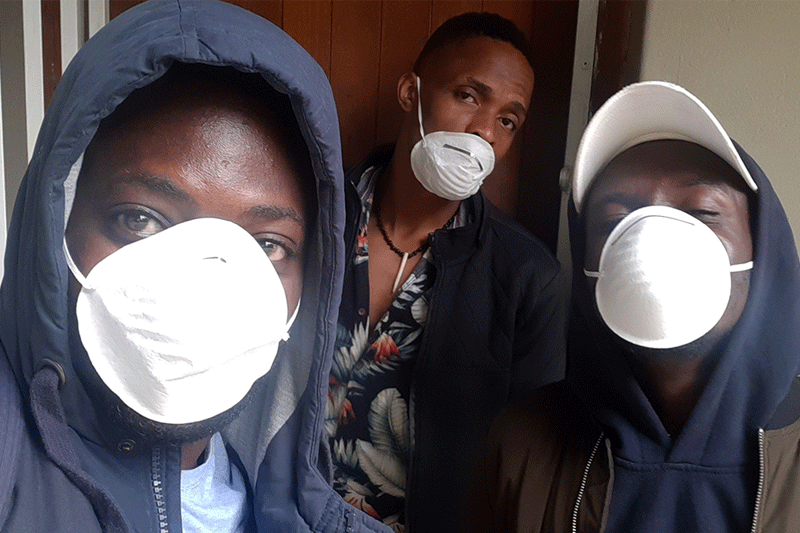 Selfie of Trevor and his friends wearing masks to prevent Covid-19