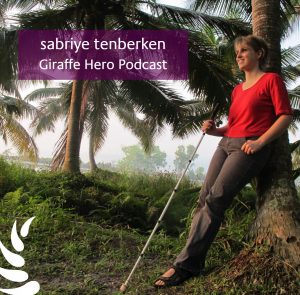 Sabriye Tenberken leaning agains a palmtree on the kanthari campus in kerala 