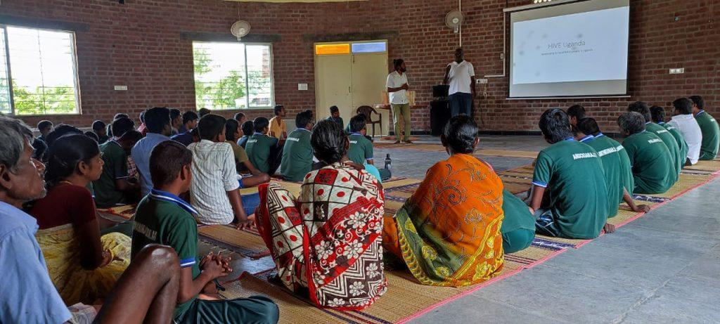 Ojok and Karthik share experiences with Sristi Village members
